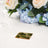 Gold geometric stand with transparent acrylic, ideal for floral displays or table settings.