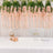 Pink floral garland decor with table setting and gifts for a celebration.
