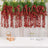 Red hanging floral arrangement with greenery on a table setting.