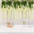 Decorative white flowers hanging above a table with gifts and glassware.