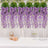 Purple wisteria flowers hanging decoratively, perfect for events and celebrations.