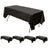 Black tablecloth draped over a folding table, set against a plain backdrop.