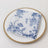 Blue floral patterned napkin on a decorative plate.