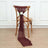 Burgundy chair sash with flower decoration on a wooden chair