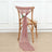 Pink sheer fabric draped on a wooden chair with a flower accent.