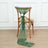 Green scarf draped on a wooden chair with a white flower accent.