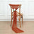 Rust-colored chair sash with flower decoration on a wooden chair.