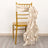 Gold chiavari chair with ruffled satin sash draped over the back.