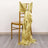 Gold satin chair sash draped elegantly over a chair.