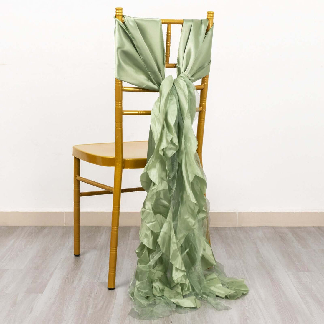 Green satin chair sash tied elegantly on a wooden chair.
