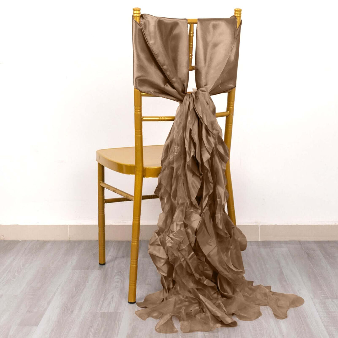 Elegant tan chair sash cascading down a gold chair.