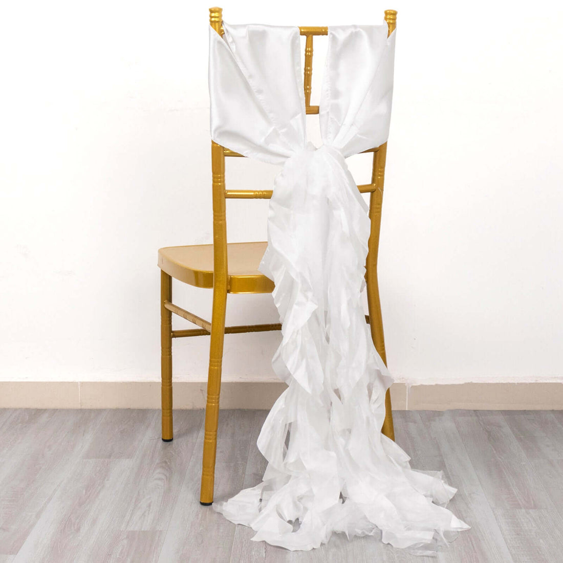 White chair sash draped elegantly over a gold chair.
