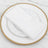 White napkin on an elegant gold beaded plate.