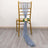 Blue sheer fabric draped on a gold chair with a rose accent.