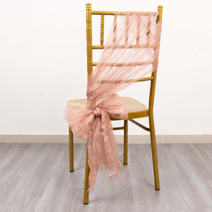 Peach tulle chair sash draped on a gold chiavari chair