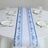 Blue and white decorative table runner on a dining table setting.