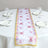 Floral butterfly table runner on a dining table with plates and glasses.