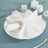 White linen napkin elegantly arranged on a plate with rose gold napkin ring.