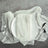 Elegant table setting with white plate, linen napkin, and silver cutlery.