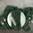 Green textured napkin on a plate with cutlery arranged elegantly.