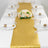 Elegant gold table runner with floral centerpiece and glassware set for dining.