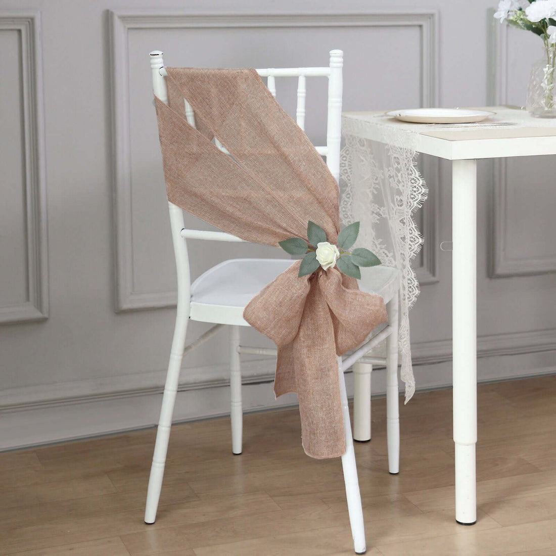 Elegant burlap chair sash with flower decoration for wedding or event decor.