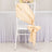 Champagne satin chair sash tied in a bow on a white chair.
