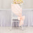 Peach satin chair sash tied with a bow on a white chair