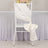 Elegant white chair sash tied in a bow for wedding decor.