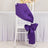 Purple satin chair sash tied in a bow on a white chair.