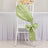 Green satin chair sash tied in a bow on a white chiavari chair.