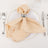 Elegant beige napkin with silver napkin ring on a dinner plate.