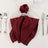 Burgundy napkin elegantly folded on a plate with silver cutlery