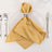 Gold satin napkin elegantly folded on a white plate with silver napkin ring.