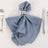 Blue satin napkin elegantly styled on a plate with a silver napkin ring.