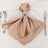 Elegant beige satin napkin with silver ring on a white plate.