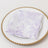 Lavender floral napkin on a decorative plate