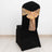 Black chair cover with gold sequined bow, elegant event decoration.
