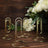 Gold paper clip stands on wooden surface with flowers.