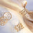 Gold geometric napkin rings elegantly displayed on a soft fabric backdrop.
