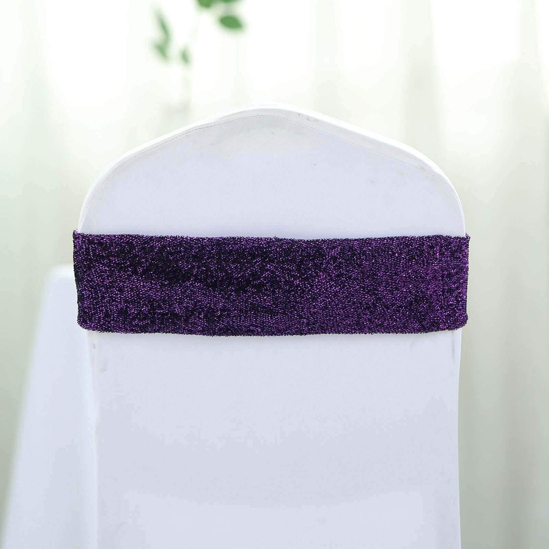 Purple chair cover sash on a white chair