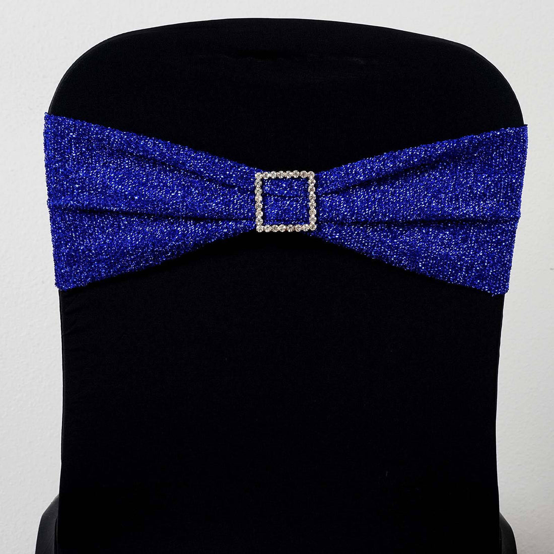 Blue rhinestone chair sash with a decorative buckle.