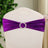 Purple chair sash with rhinestone buckle on a white chair.