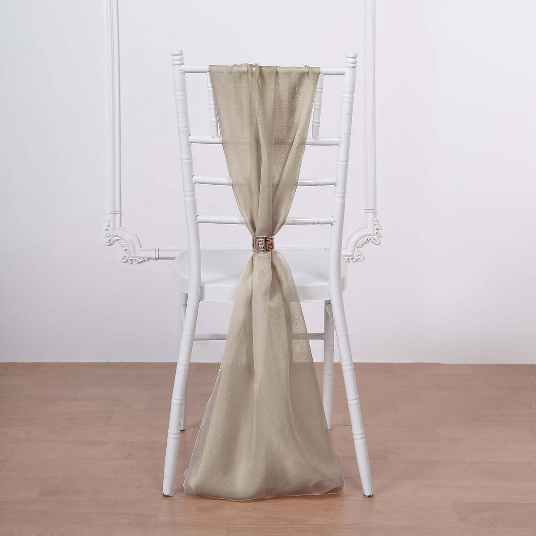 Gold chair sash draped on a white chiavari chair.
