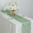 Elegant mint green table runner with gold accents, styled with floral centerpiece.