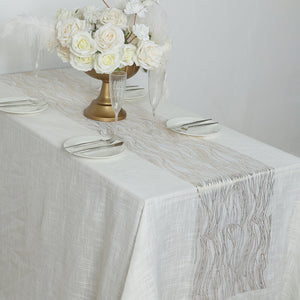 Elegant table setting with floral centerpiece and decorative table runner.