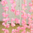Pink flower garland with cascading blooms on a white backdrop