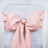Pink satin chair sash with rhinestone buckle.