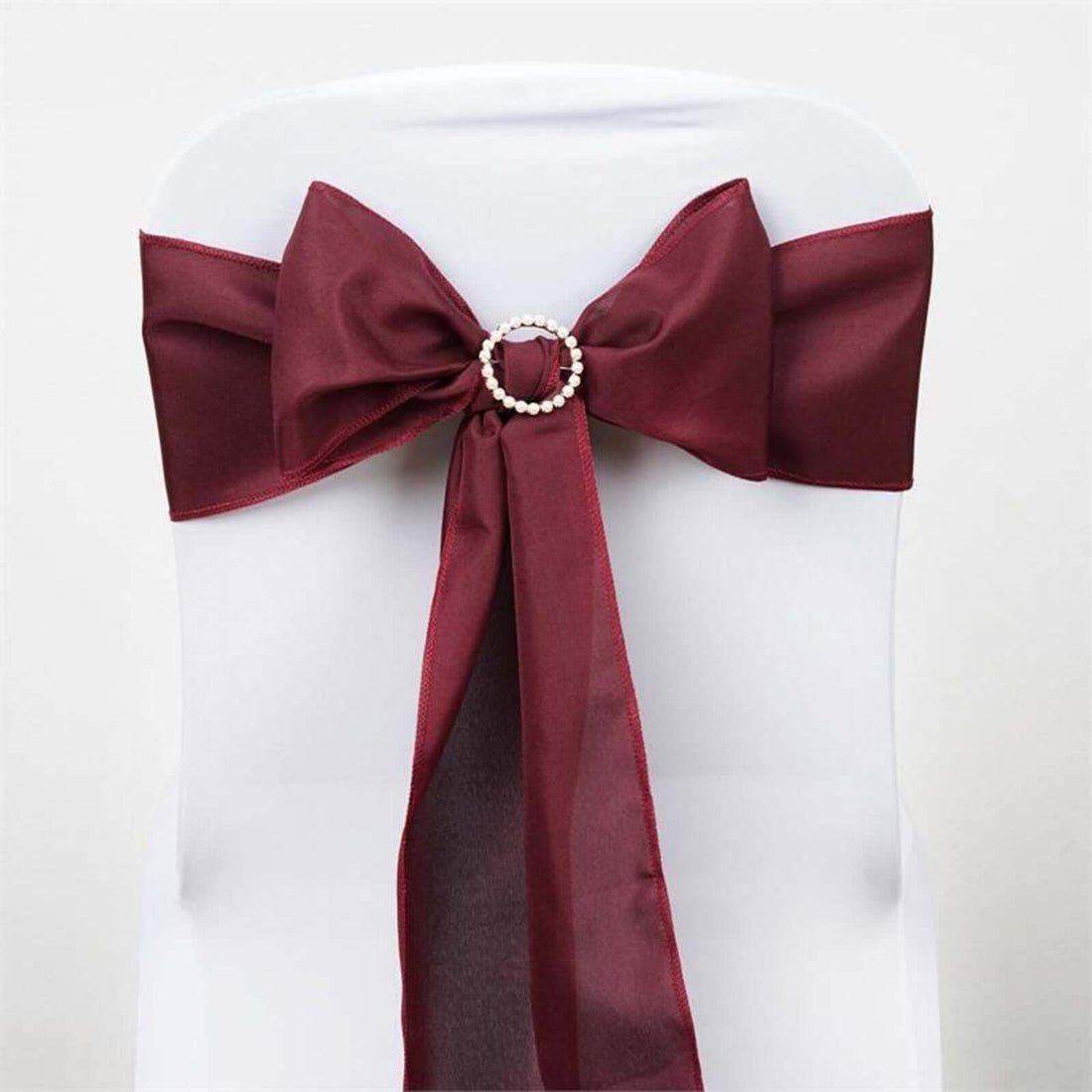 Burgundy chair sash with pearl detail for elegant decor #whtbkgd