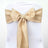 Gold satin chair sash with pearl embellishment for elegant decor. 